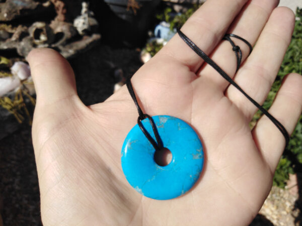 Blue Howlite Pi Stone donut in palm of hand