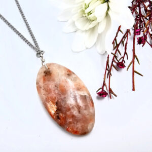 Sunstone oval pendant on a stainless steel necklace
