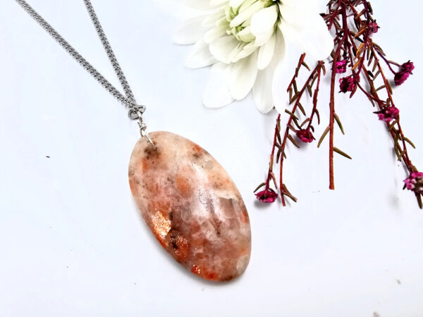 Sunstone oval pendant on a stainless steel necklace